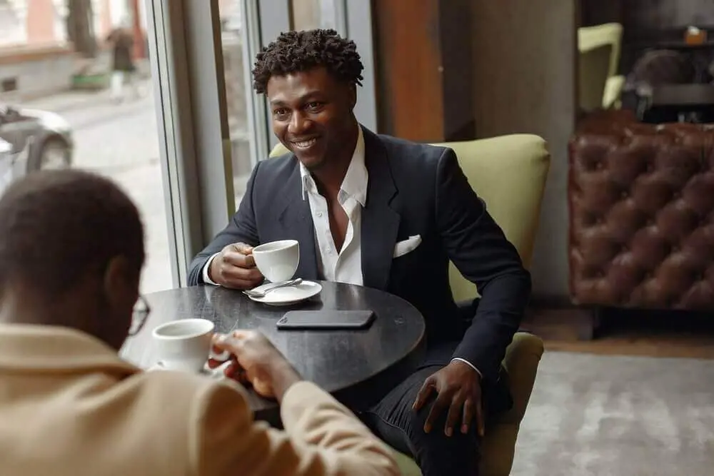 Two business men drinking coffee | Guide My Growth