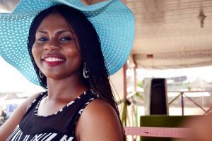 Smiling lady wearing a blue hat | Guide My Growth