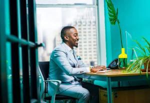 Man at desk with keyboard | Guide My Growth