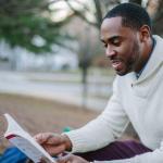 Man reading a book | Guide My Growth