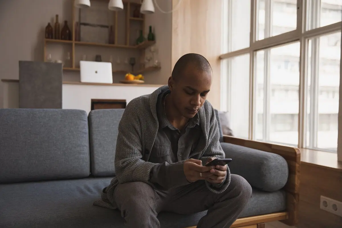 Young man with smartphone | Guide My Growth