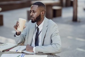 A seated man with a drink